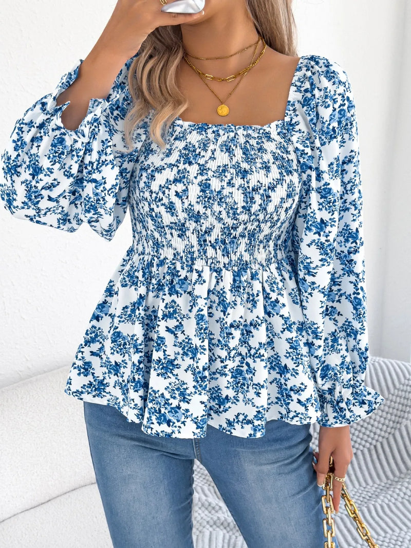 Women's floral blouse with a square neckline and flounce sleeves, featuring a light, airy fabric and a delicate floral pattern.